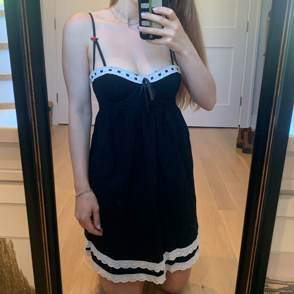 Black mini dress eyelet details with bows and zipper up back white trim